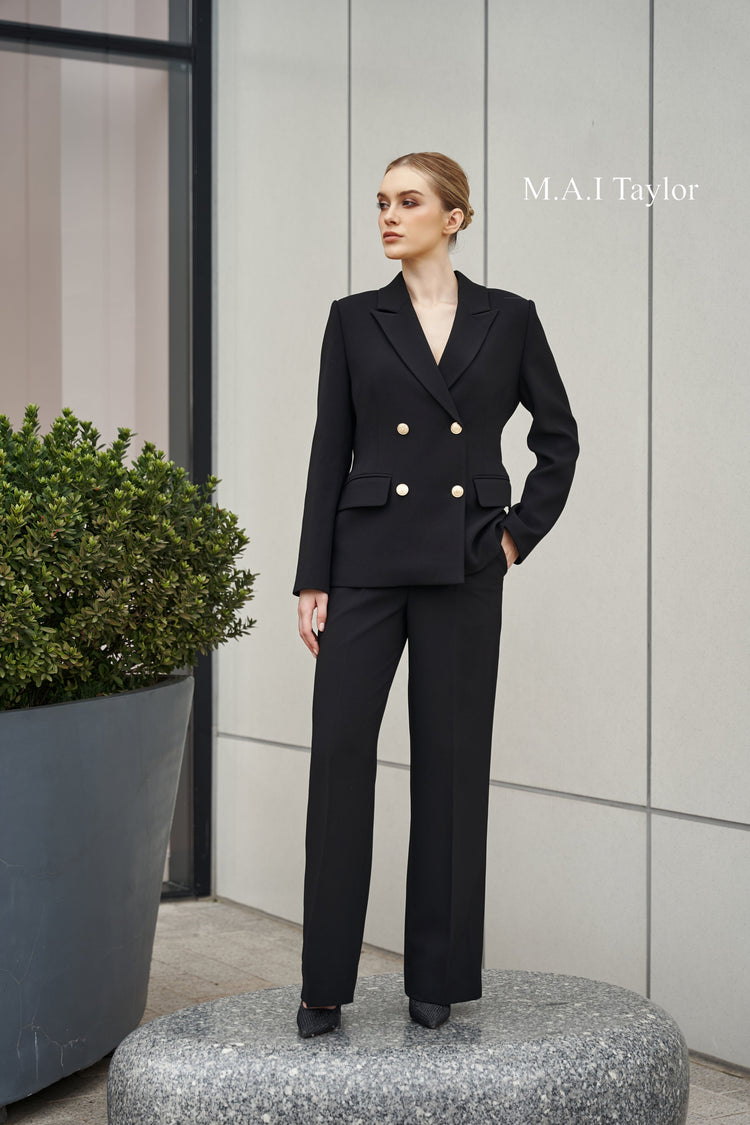 Confident woman in a sharp black double-breasted suit – part of “The Presence Code” by MAI TAYLOR.